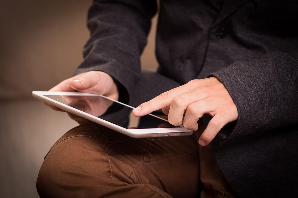 Man on tablet using technical SEO