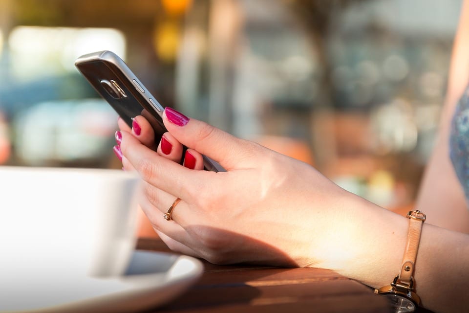 Woman on her phone looking at a mobile friendly website