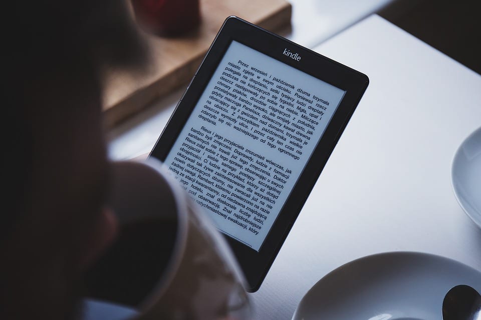 person-reading-ebook-on-kindle